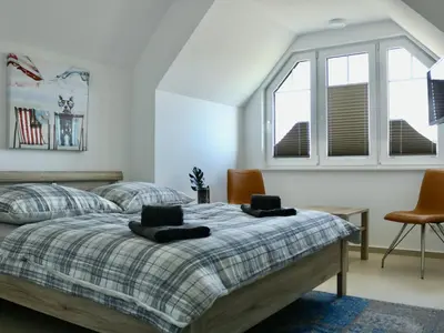 Ein Bett oder Betten in einem Zimmer der Unterkunft Yvette 1 - Idyllisches Ferienhaus - Ihr Platz für Erholung in Zingst
