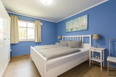 Ein Bett oder Betten in einem Zimmer der Unterkunft HMuschelsucher, Birkenstraße 7a, App 4