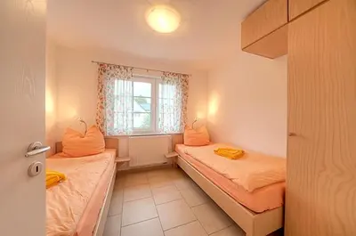 Ein Bett oder Betten in einem Zimmer der Unterkunft Strandglück FH 2