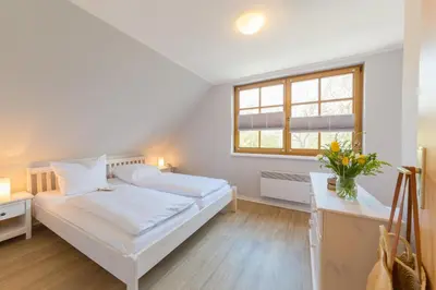Ein Bett oder Betten in einem Zimmer der Unterkunft Doppelhaus am Deich 1 - [#118593]