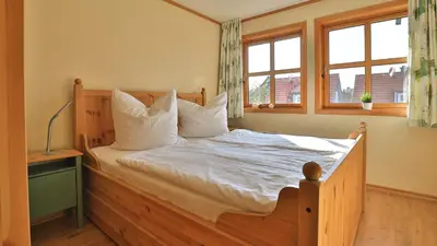 Ein Bett oder Betten in einem Zimmer der Unterkunft Heideröschen Park - Haus 5a
