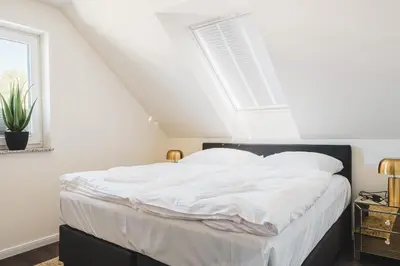 Ein Bett oder Betten in einem Zimmer der Unterkunft Dünenquartier Apartment 25