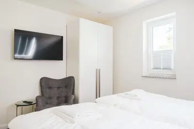 Ein Bett oder Betten in einem Zimmer der Unterkunft Dünenquartier Apartment 29